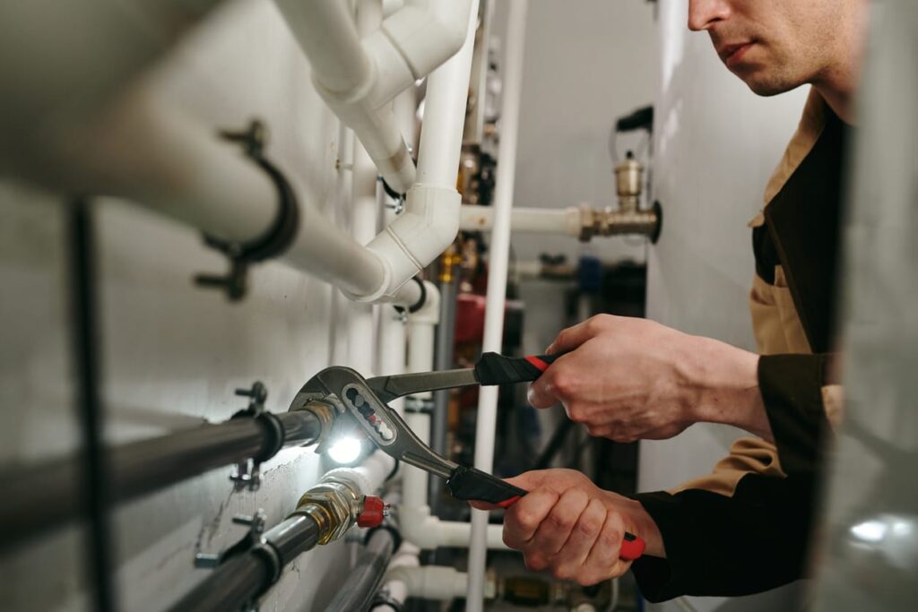 Plumbers maintaining commercial plumbing pipes in Brandon