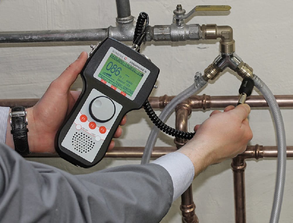 Plumber testing pipes with electronic leak detection equipment in Brandon