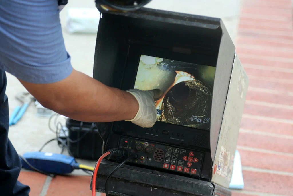 Technician viewing a drain inspection camera in Brandon
