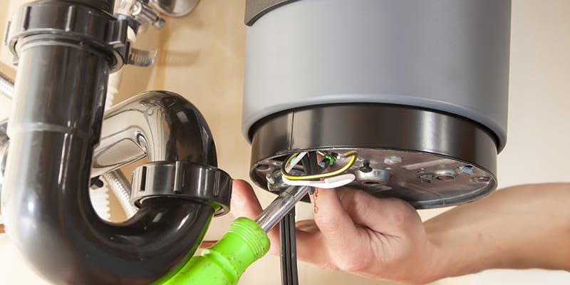 Technician repairing the heating element of a water heater in Brandon